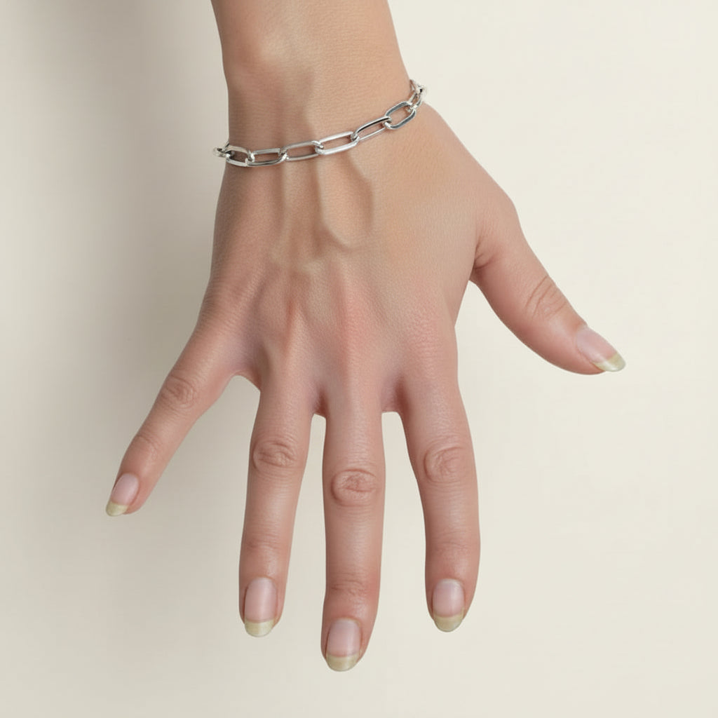 Silver-toned link bracelet with oval segments on a wrist