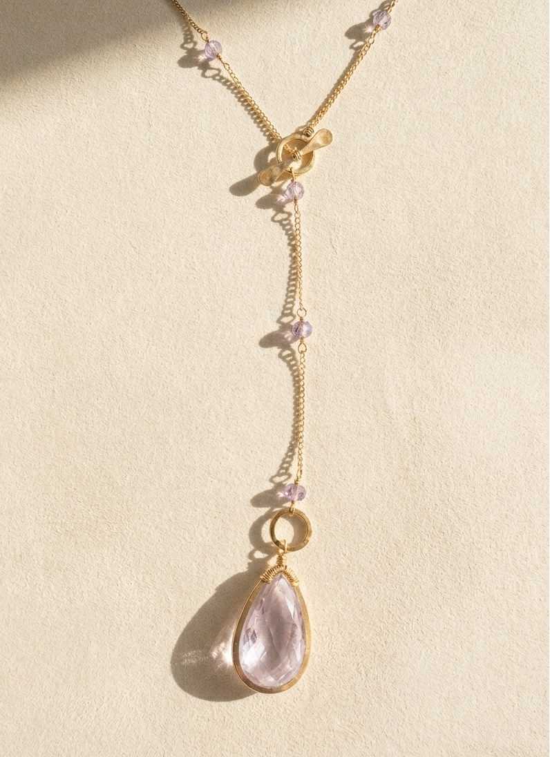 Gold lariat necklace with lilac bead clusters and teardrop crystal pendant