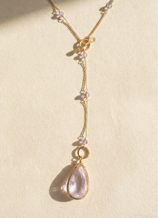 Gold lariat necklace with lilac bead clusters and teardrop crystal pendant