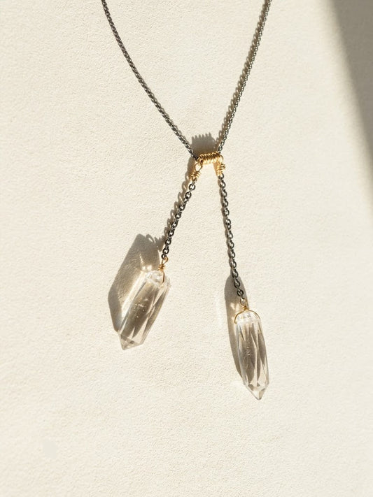 Two-tone crystal quartz lariat necklace with two dangling faceted crystals and gold accents