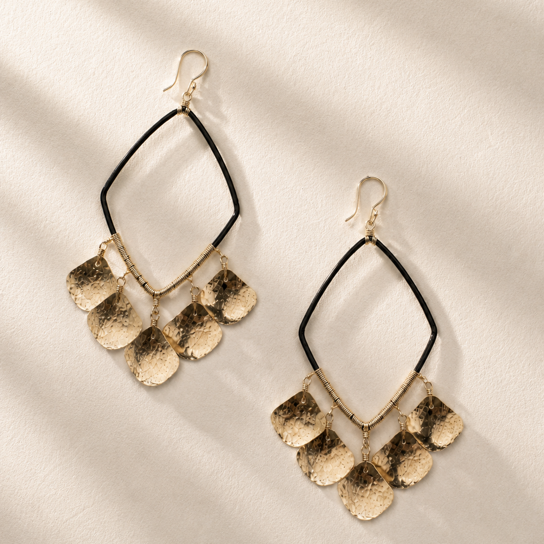Gold-tone dangle earrings with black wire teardrop hoops and coin-like charms
