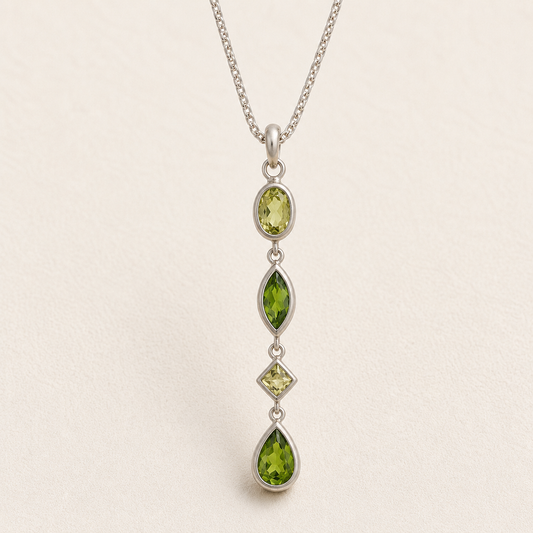Gemstone drop necklace with four green faceted marquise pendants on silver chain