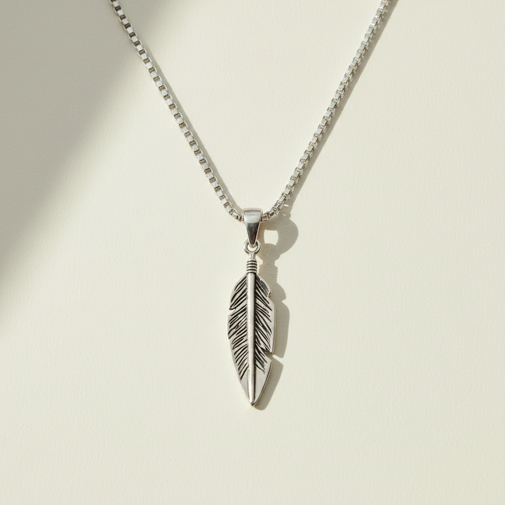 Oxidized feather pendant necklace with silver-tone feather charm, front view