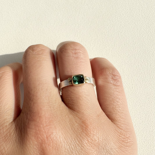 Dark green square tourmaline aura ring on silver band with gold prongs