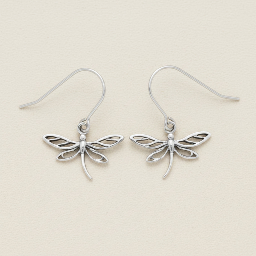 Silver dragonfly dangle earrings with delicate openwork wings and curved hooks.