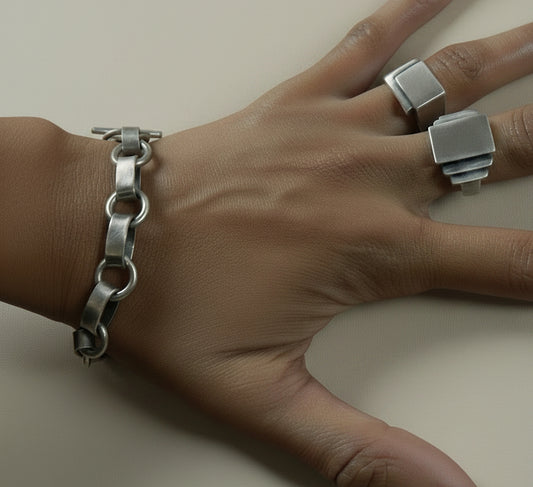 Silver circle link bracelet with toggle bar detail, worn on wrist