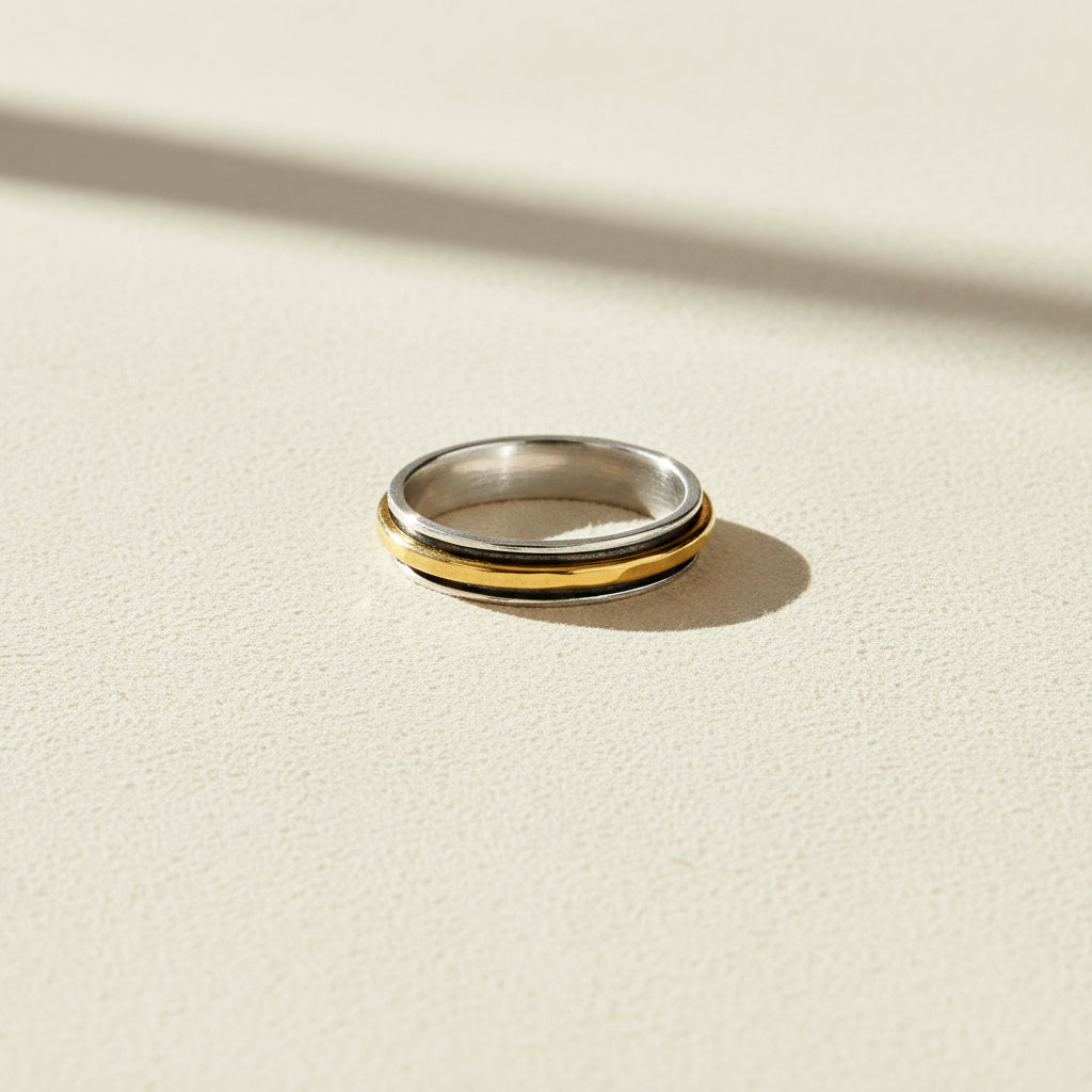 Two-tone hammered spinner band ring in silver and gold, smooth central band