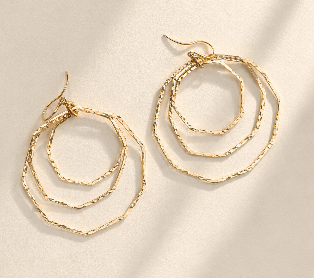 Gold-tone layered hoop earrings with braided chain orbit rings