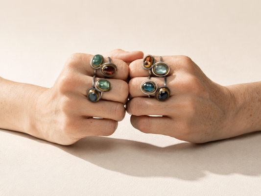 Teal oval gemstone crescent rim ring, silver-tone band with gold bezel