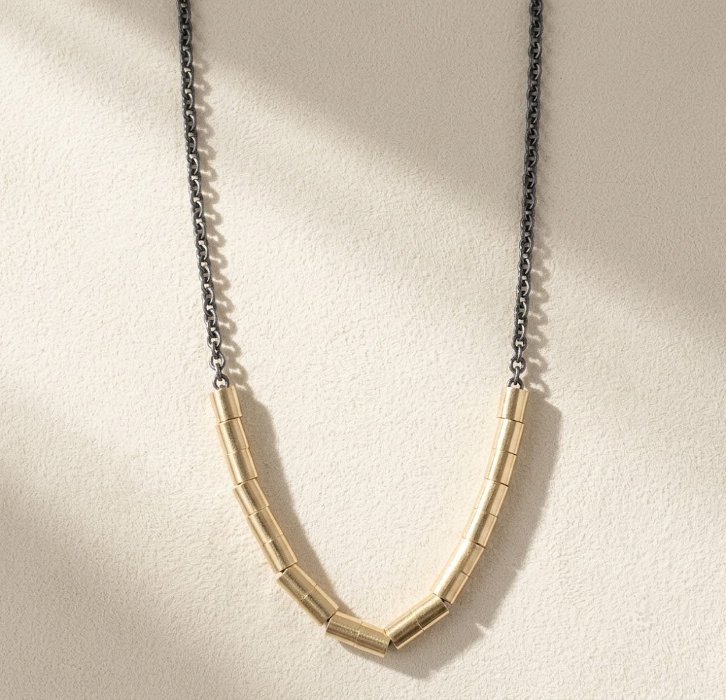Gold-tone bar link necklace with short silver-tone chain and curved V shape