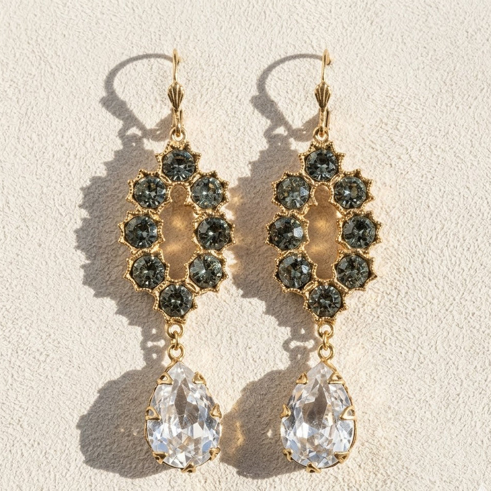 Gold-tone chandelier earrings with dark faceted clusters and teardrop clear crystals