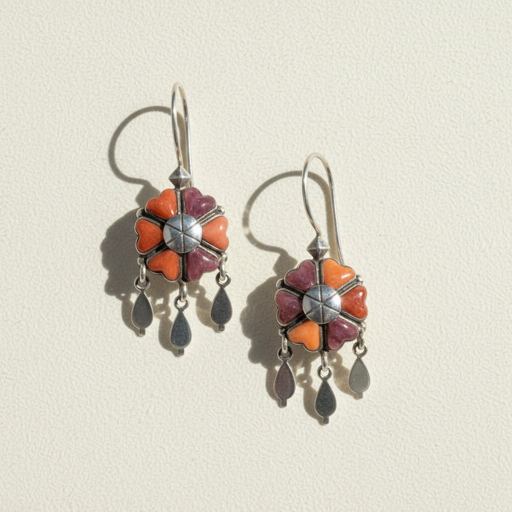 Dangling flower earrings with orange and purple petals, silver-tone center, and teardrop charms