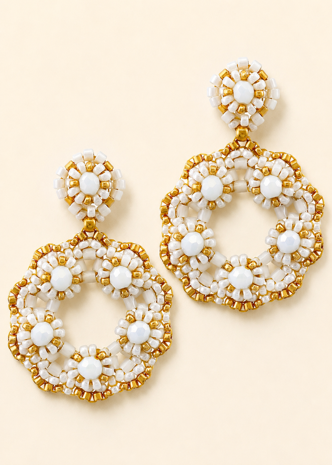Beaded open-circle post earrings with white bead accents and gold trim