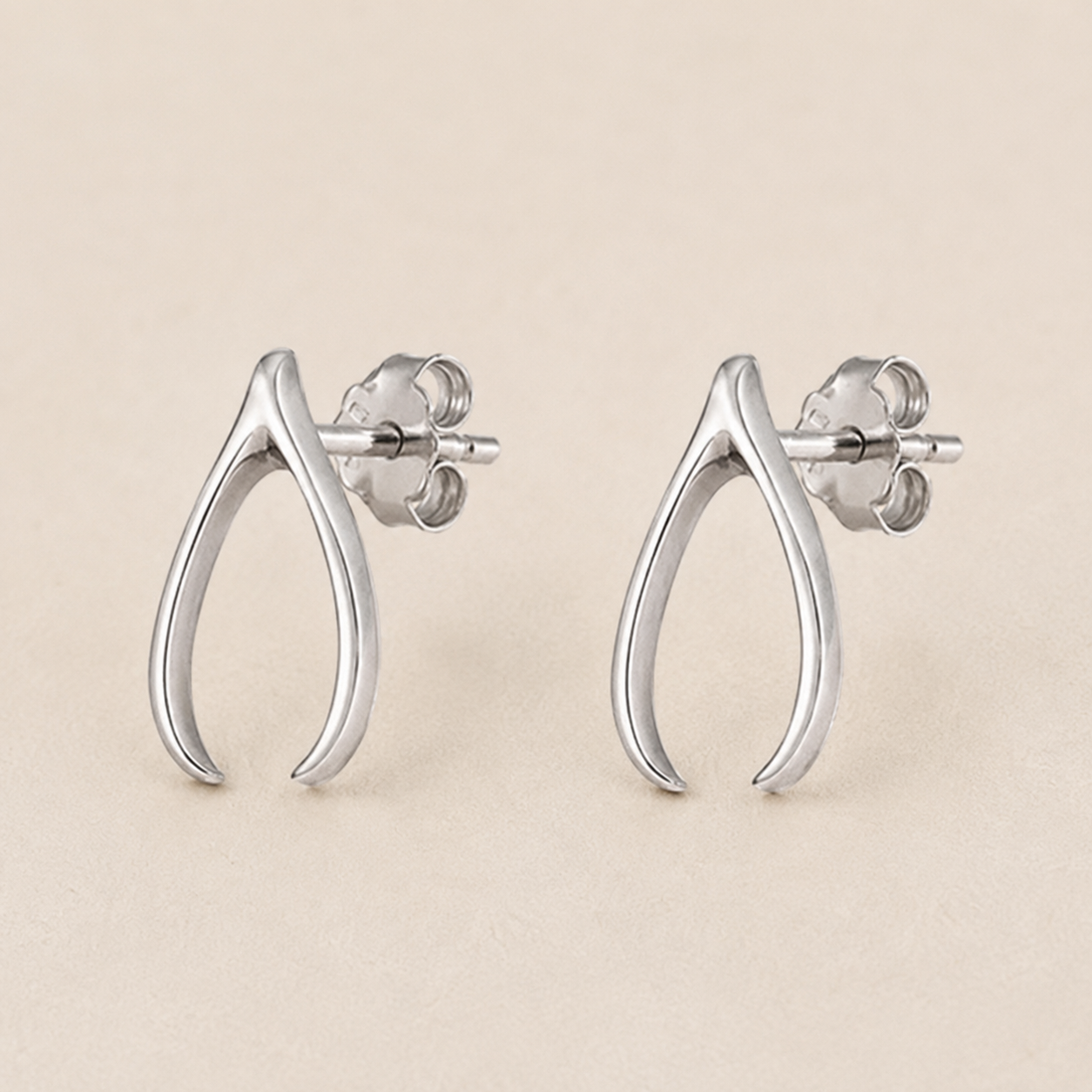 Silver teardrop wishbone stud earrings with butterfly back posts