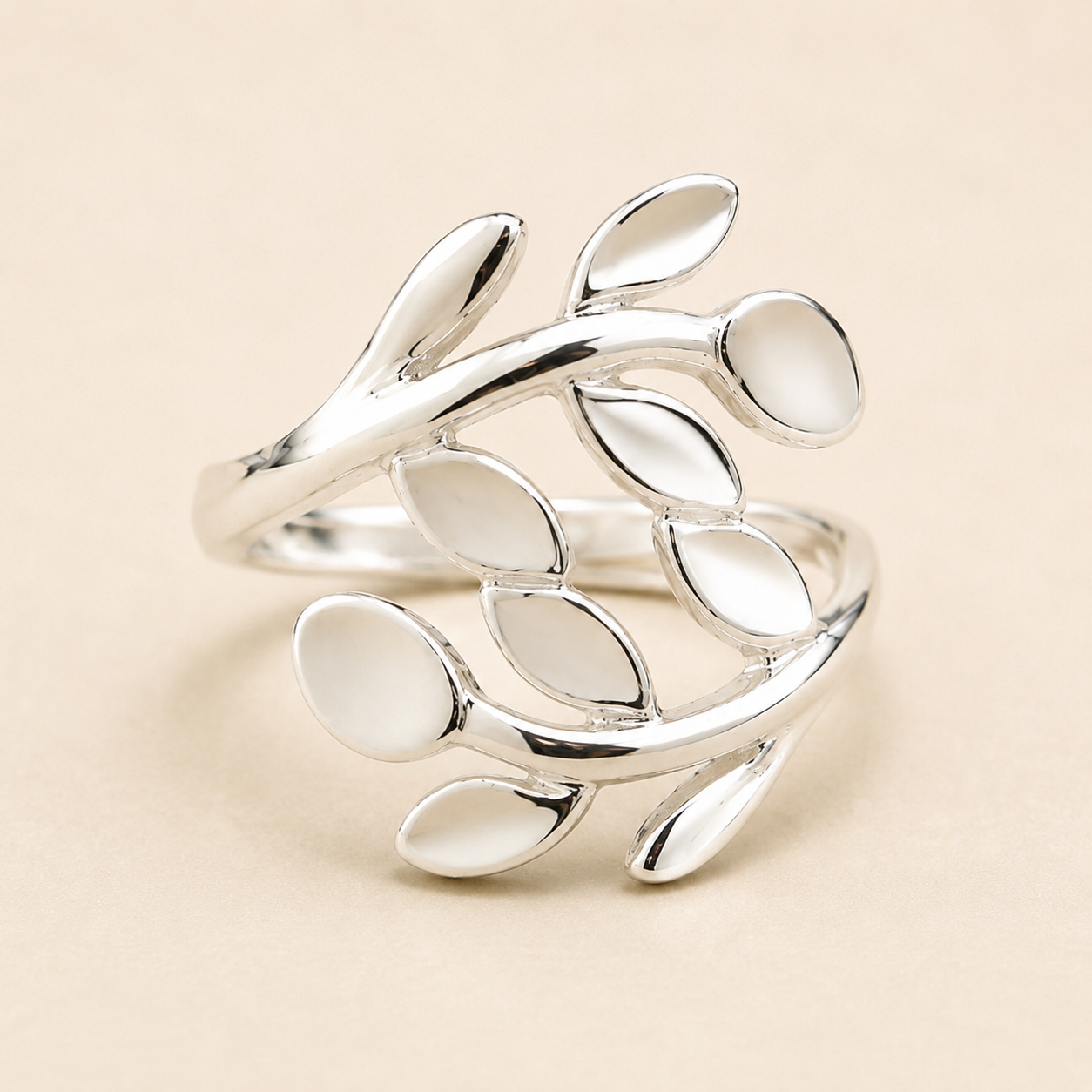 Silver leaf-vine ring with connected oval leaf accents, polished metal band