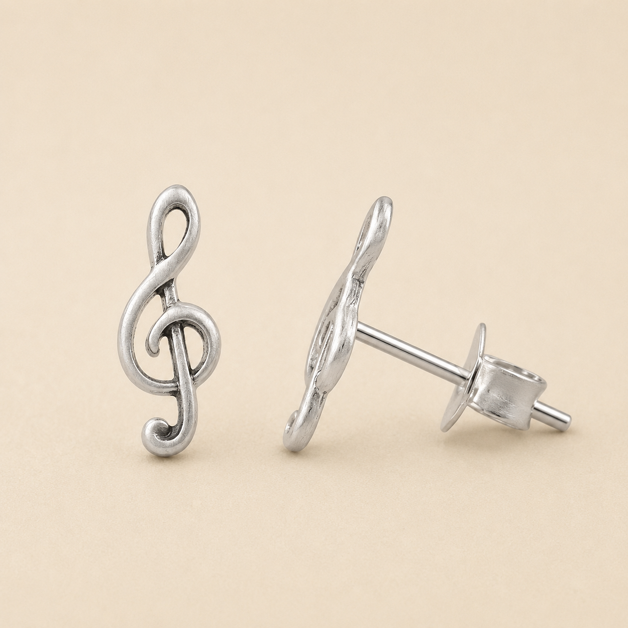 Silver treble clef knot stud earrings with metal post backing
