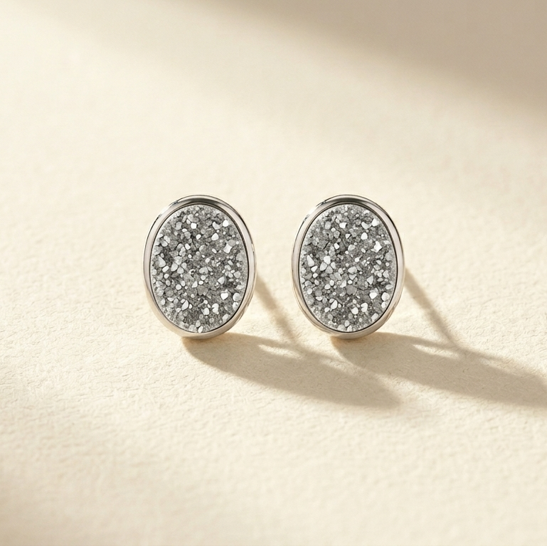 Sterling silver oval druzy stud post earrings, glittering gray crystal texture.