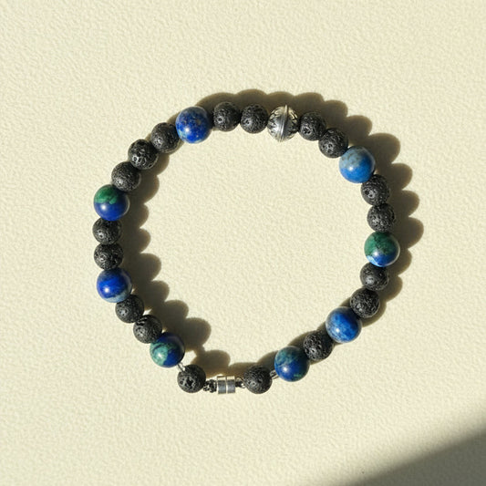 Beaded lava stone bracelet with blue and green gemstone accents, silver clasp