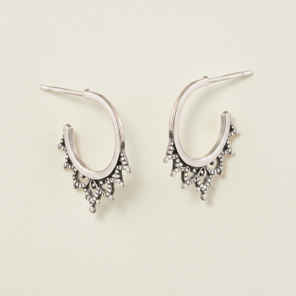 Oxidized filigree hoop earrings with small dangling charms and bead-like details