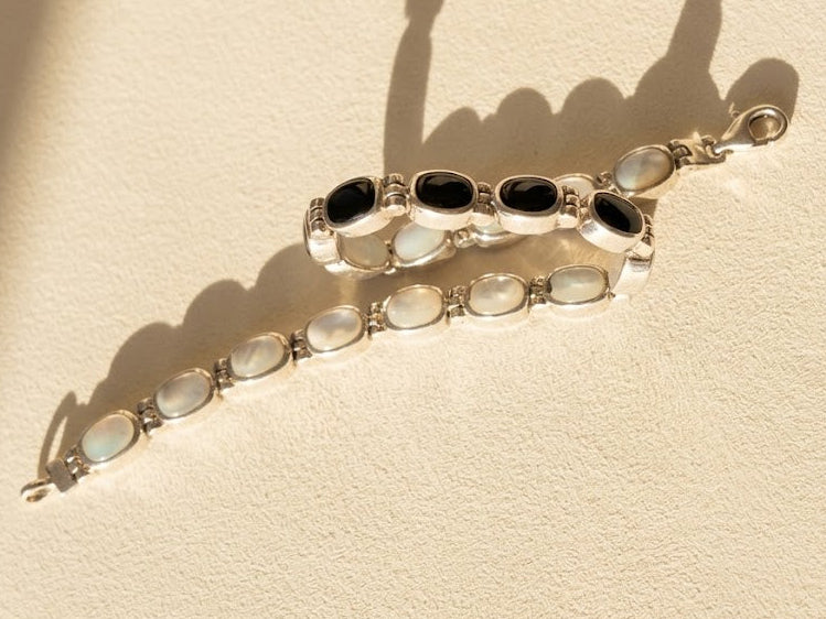 Silver reversible bracelet with white oval cabochons and linked oval frames