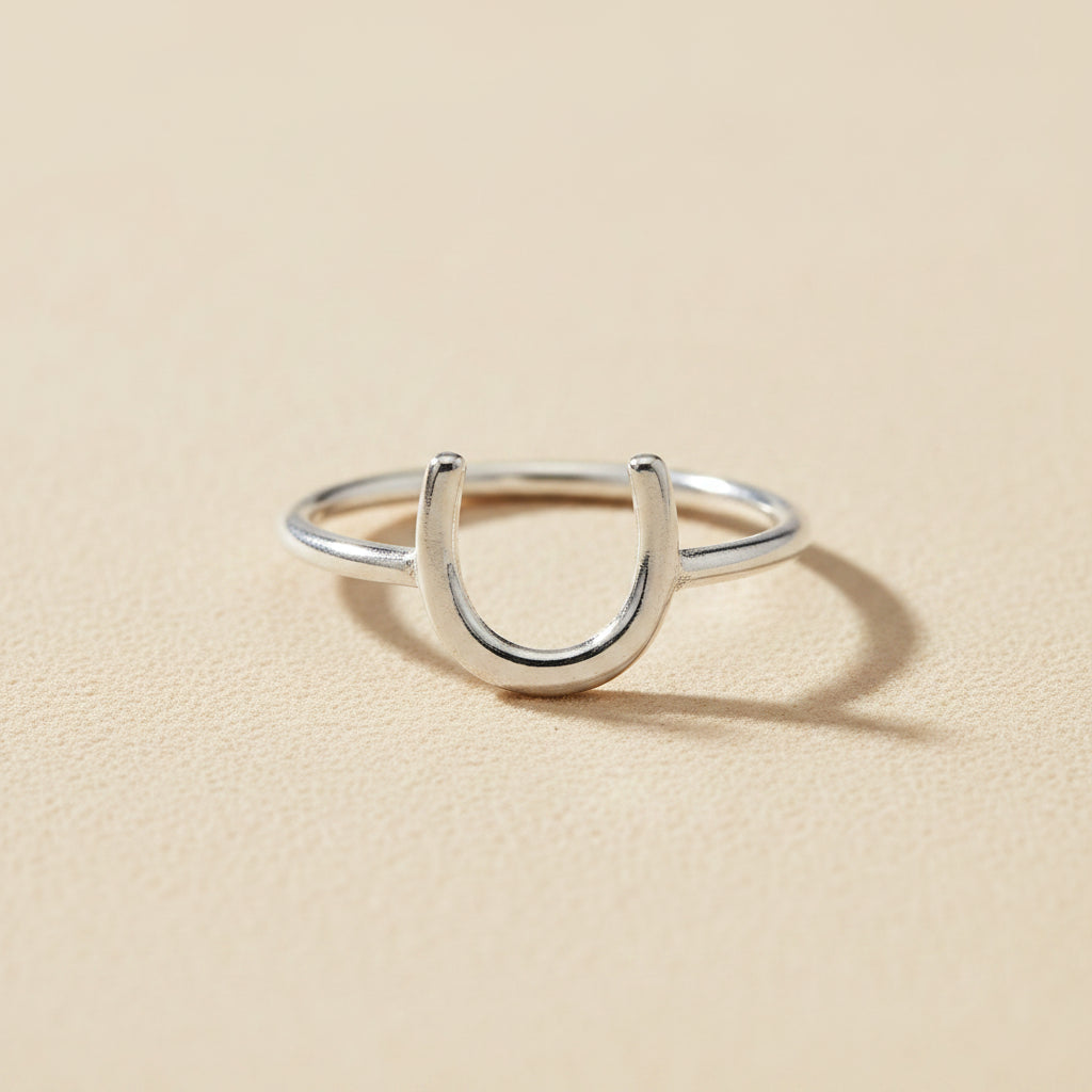 Silver horseshoe-shaped dainty ring with open U design on a slim band
