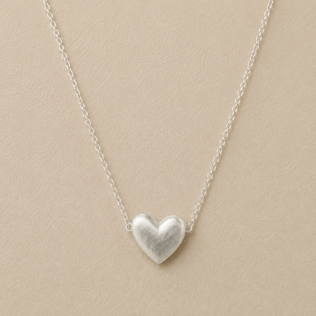 Silver-tone heart pendant necklace on a fine chain