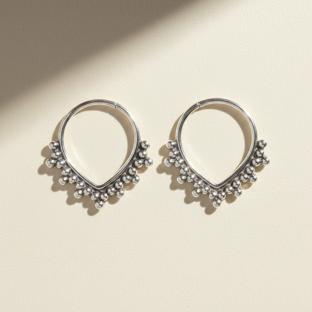 Beaded hoop earrings with small silver-tone bead fringe and teardrop outline