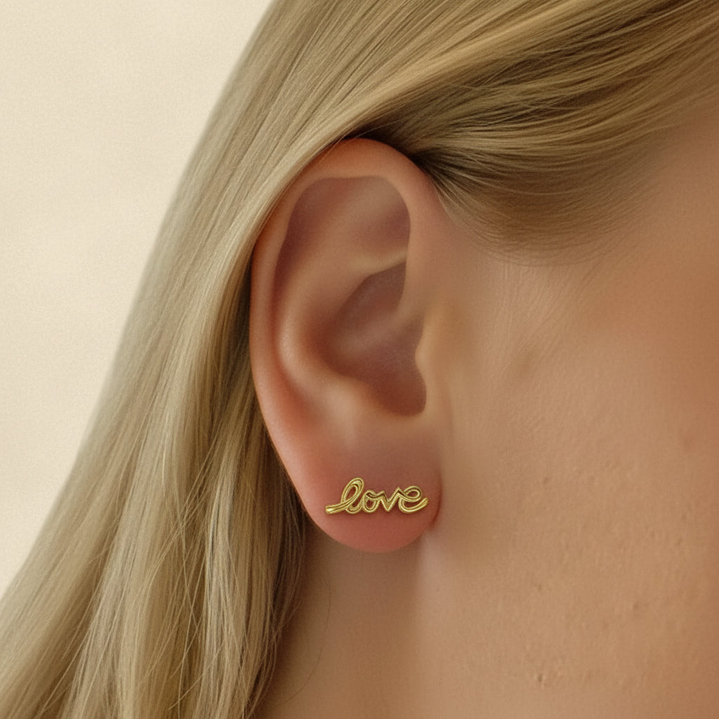 Gold Love script stud earrings, small cursive “Love” on posts