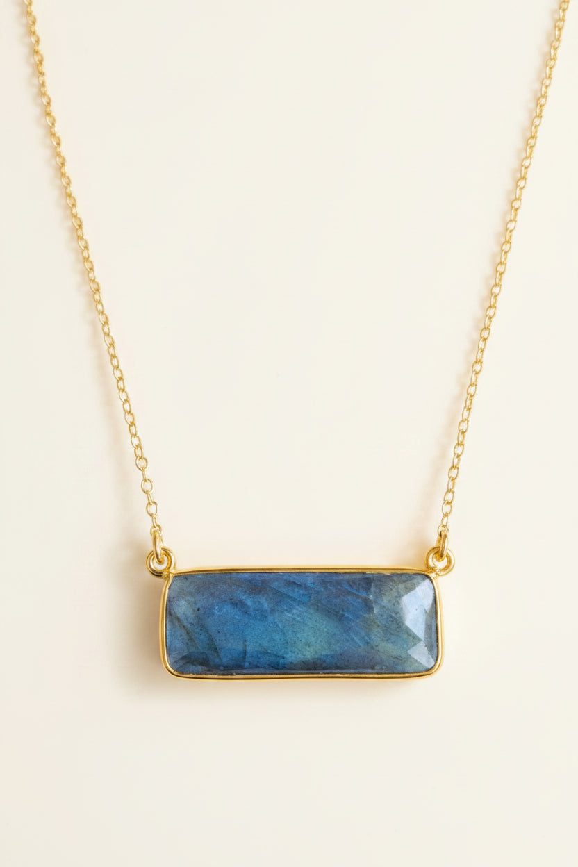 Necklace with a blue stone pendant on a white background