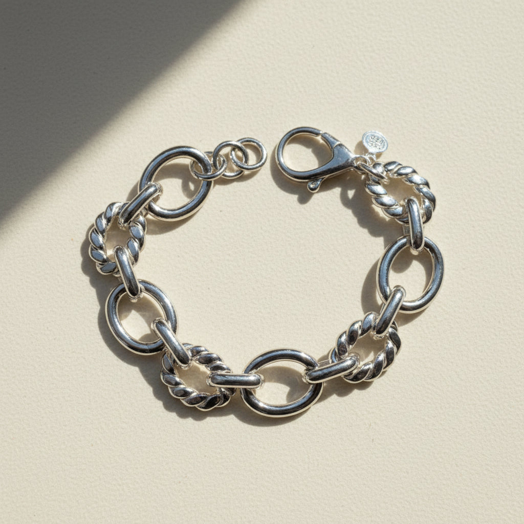 Silver-tone chain bracelet with oval and twisted link details and ring clasp