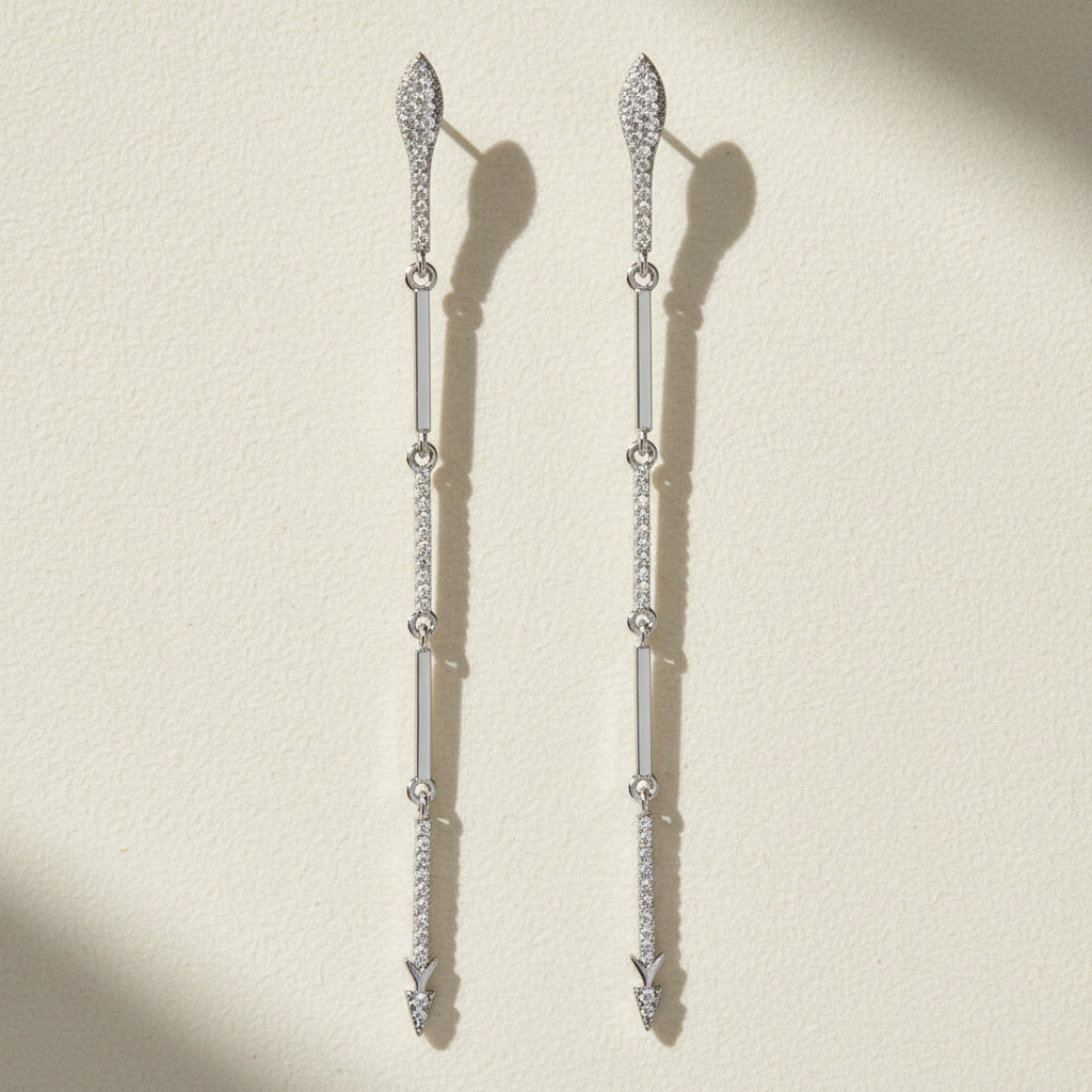 Silver-tone CZ dangle earrings with long drop design and small hanging stone accents