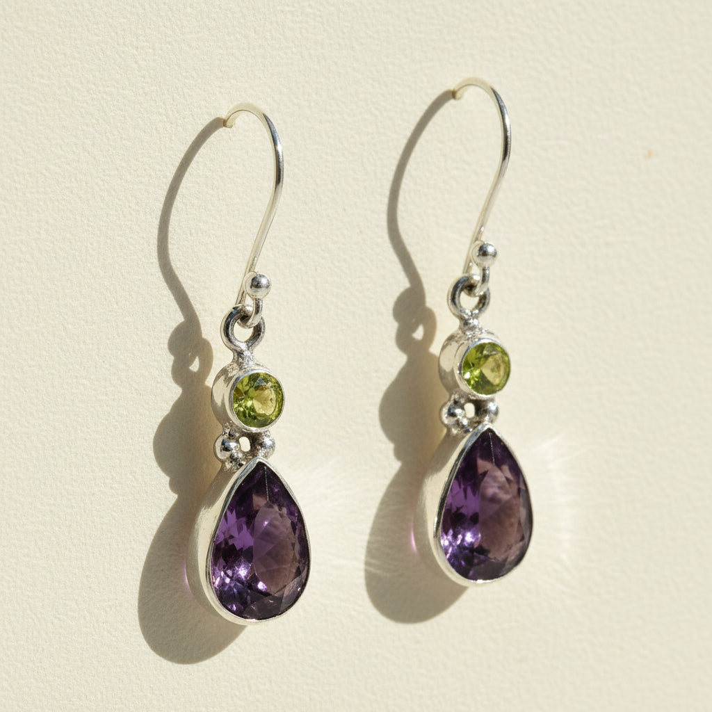 Silver-tone dangle earrings with green round and purple teardrop gemstones