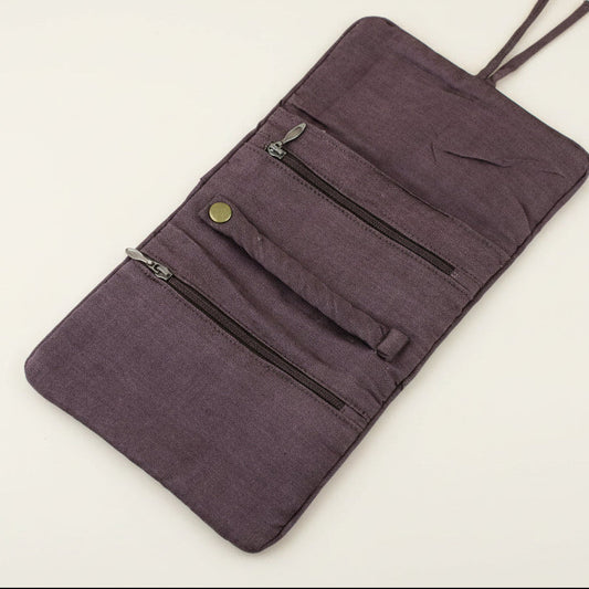 Purple fabric pouch with zippers on a light beige background