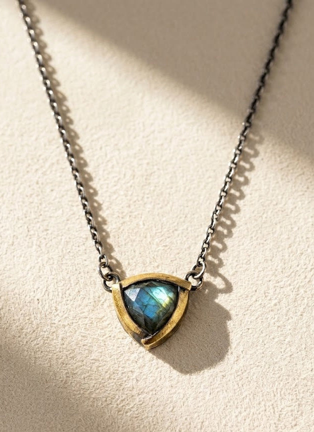 Tri-fold pendant necklace with dark chain and blue-green teardrop stone