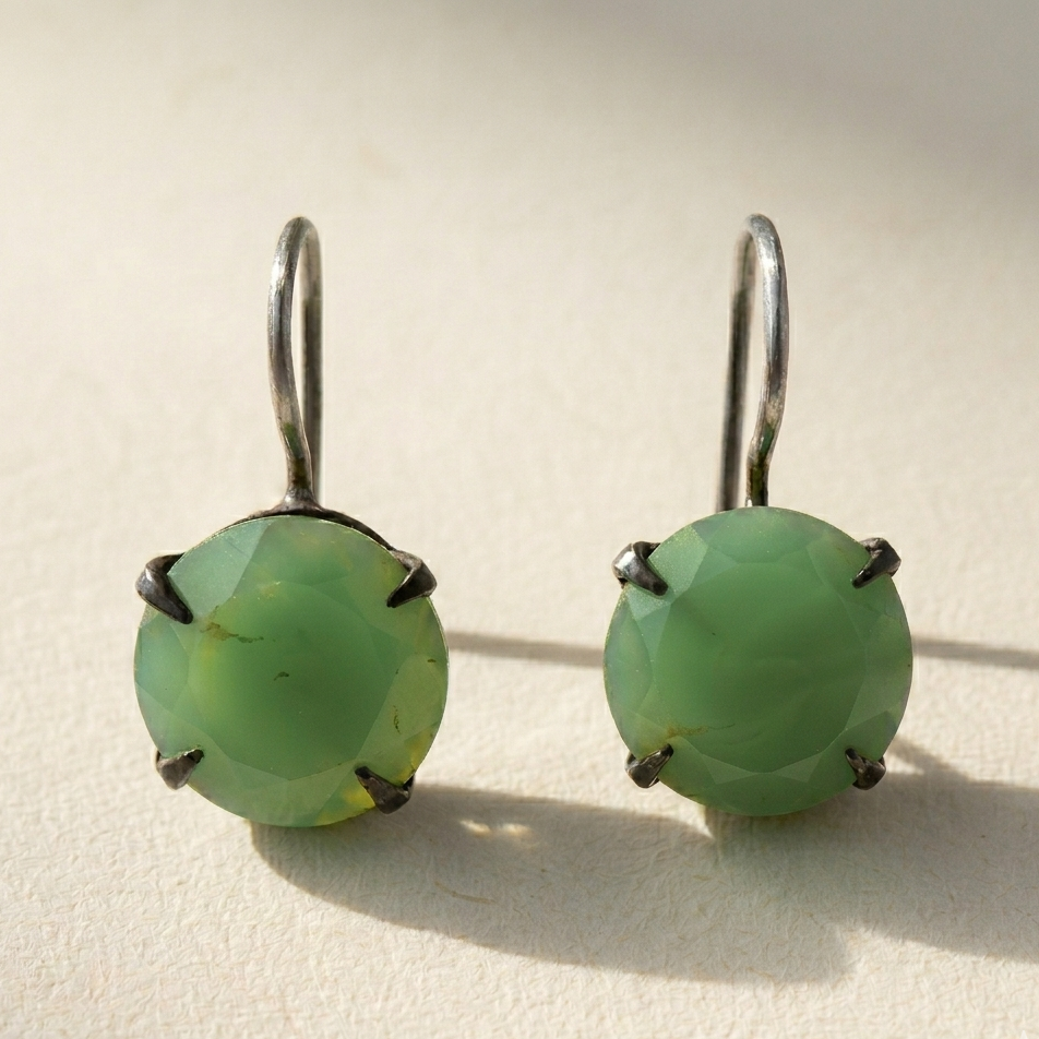 Silver-tone drop earrings with round faceted green stone in prong setting