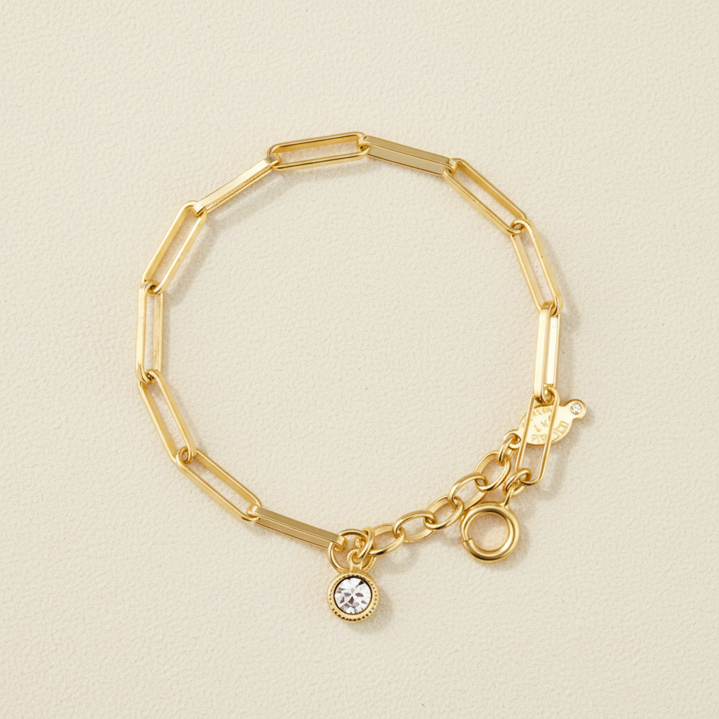 Gold-tone rectangle link bracelet with round clasp and small round crystal charm
