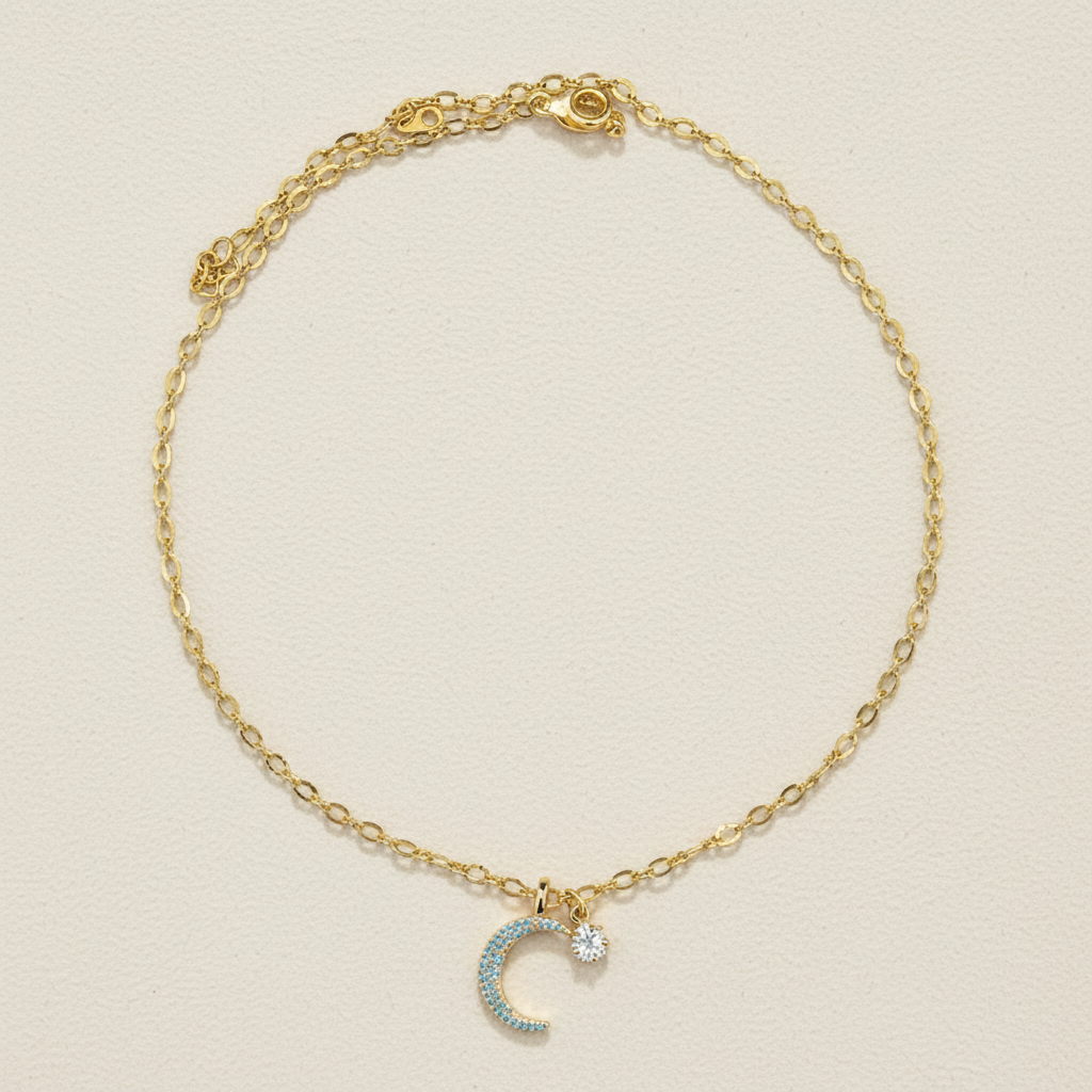 Gold-tone moon and star charm necklace with sparkling star detail