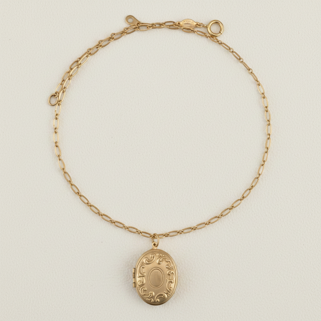 Gold-tone locket necklace with oval pendant and linked chain collar