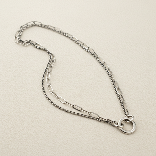 Silver-tone double chain necklace with linked chains and hammered ring detail