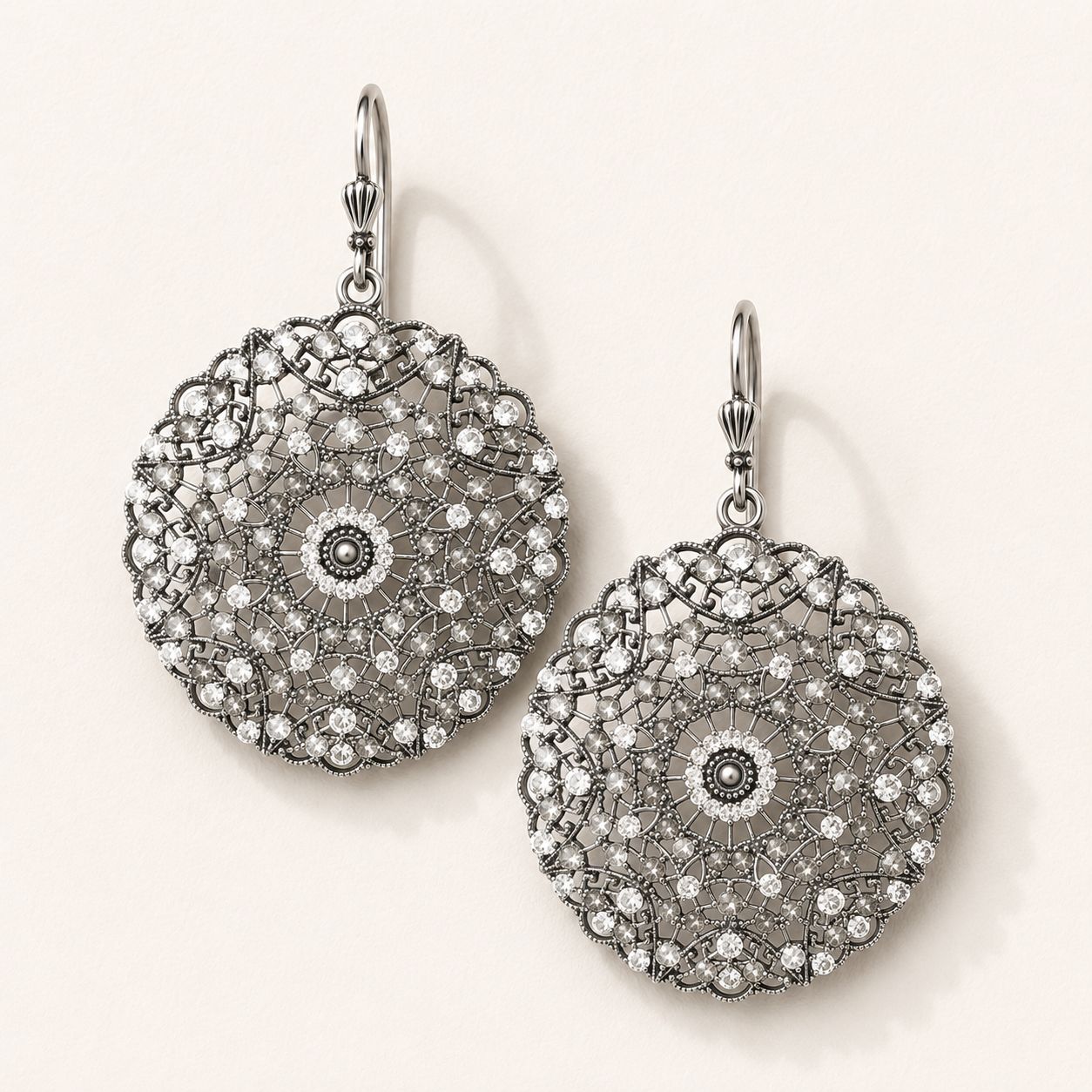 Silver drop earrings with ornate filigree and crystal-like stones