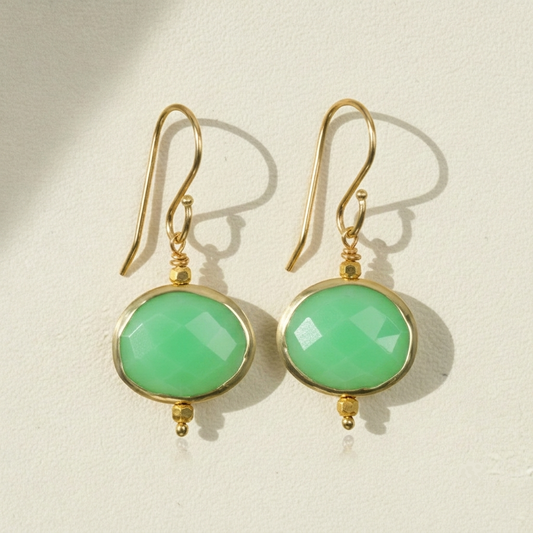 Gold-tone drop earrings with round green faceted bezel stones and fishhook backs
