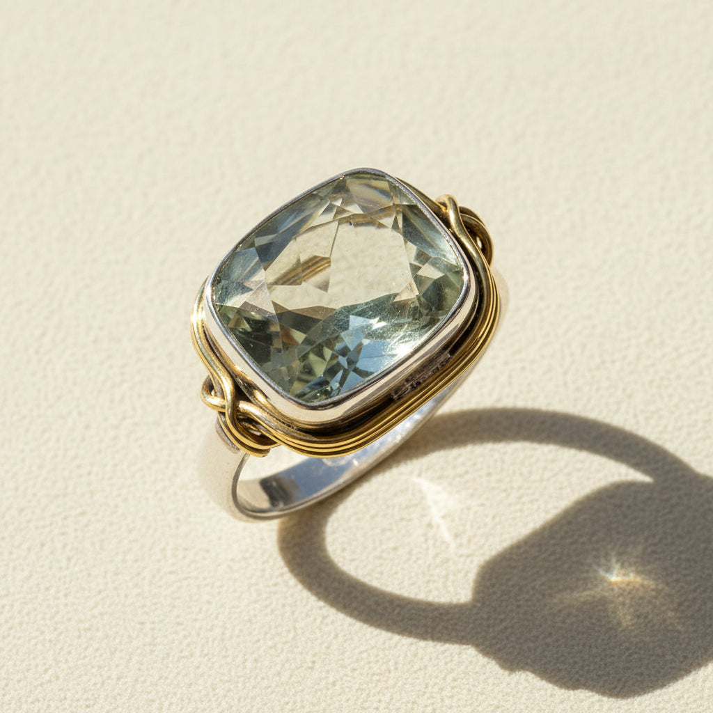 Two-tone ring with large rectangular pale green gemstone and twisted gold and silver band