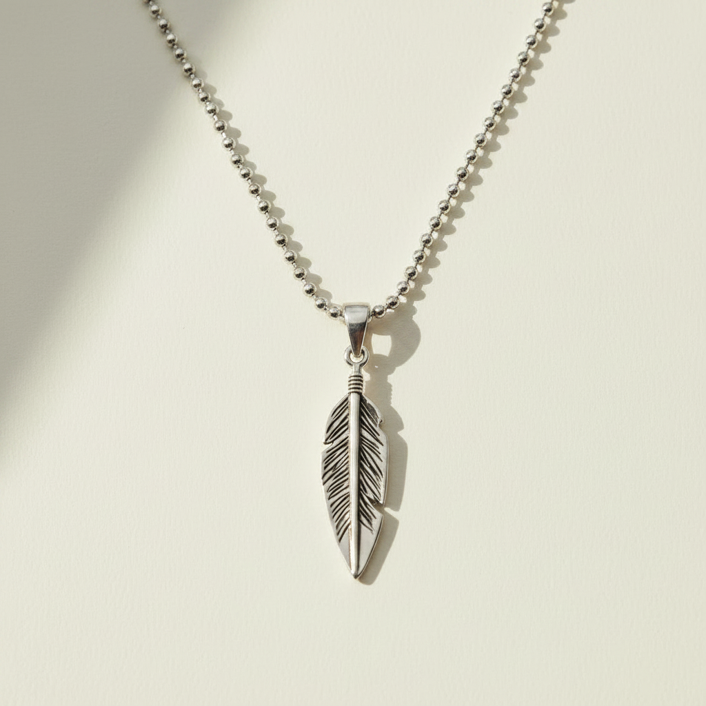 Oxidized feather pendant necklace featuring a detailed silver-tone feather charm