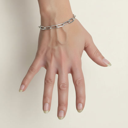 Silver-toned link bracelet with oval segments on a wrist