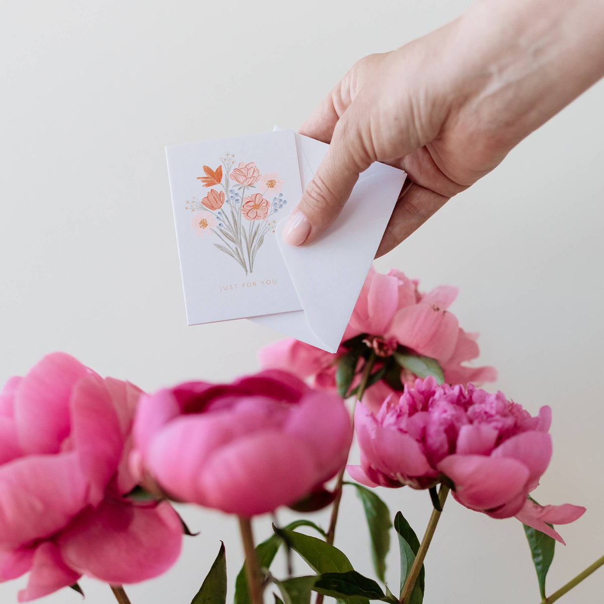Mini bouquet card held in hand, with "Just For You" message and flower illustration