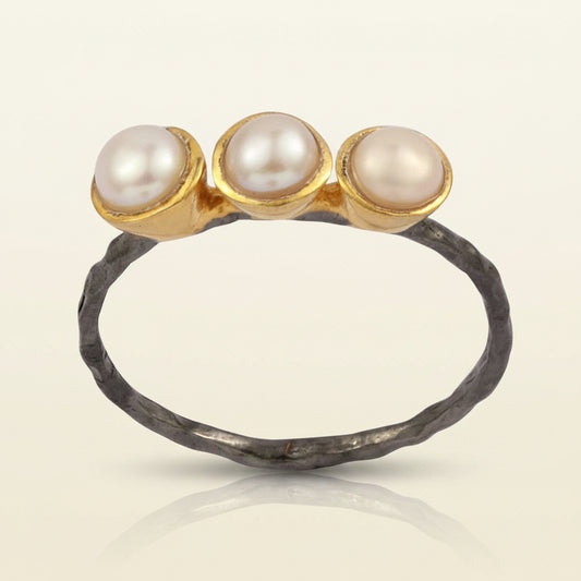 Three pearl ring with white round pearls on gold-tone tops and dark hammered band