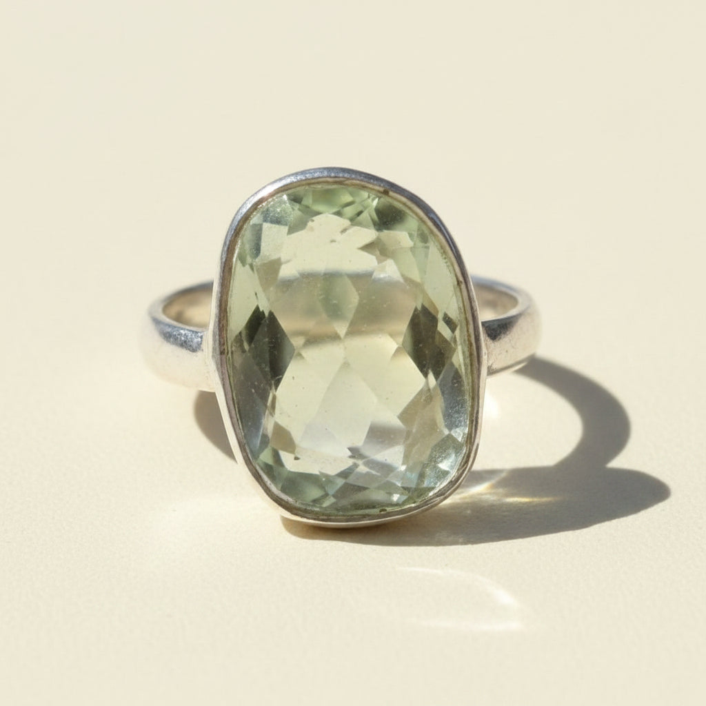 Sterling silver ring with oval faceted green gemstone