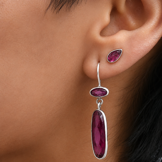 Silver-tone rhodolite garnet drop earrings with three faceted oval stones, magenta set