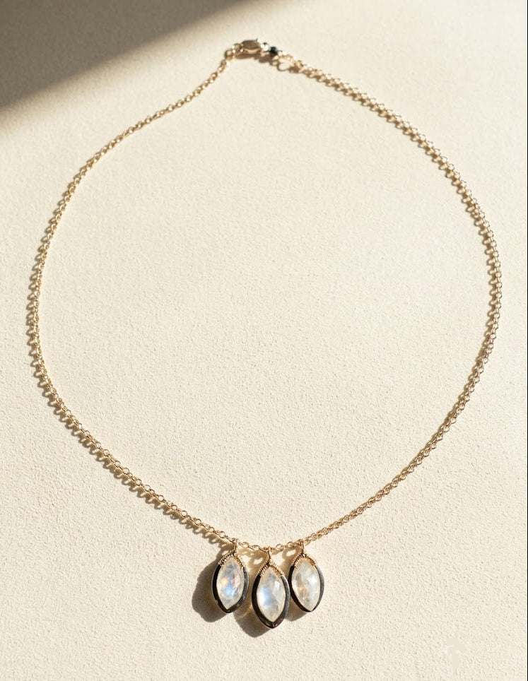 Gold tone chain necklace with three oval moonstone drops
