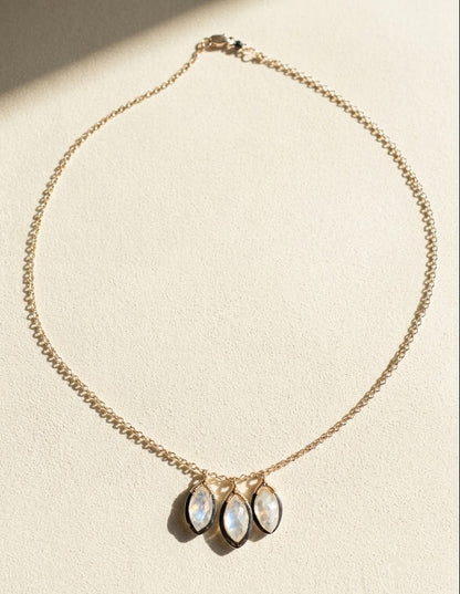 Gold tone chain necklace with three oval moonstone drops